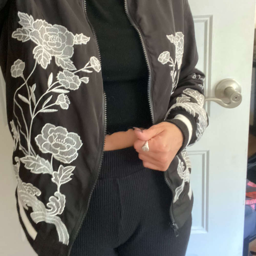Bomber jacket with white lace flower detailing